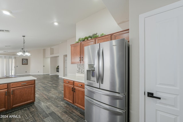 kitchen with a chandelier, dark hardwood / wood-style floors, stainless steel fridge with ice dispenser, hanging light fixtures, and backsplash