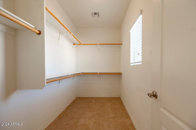 spacious closet featuring light tile patterned floors