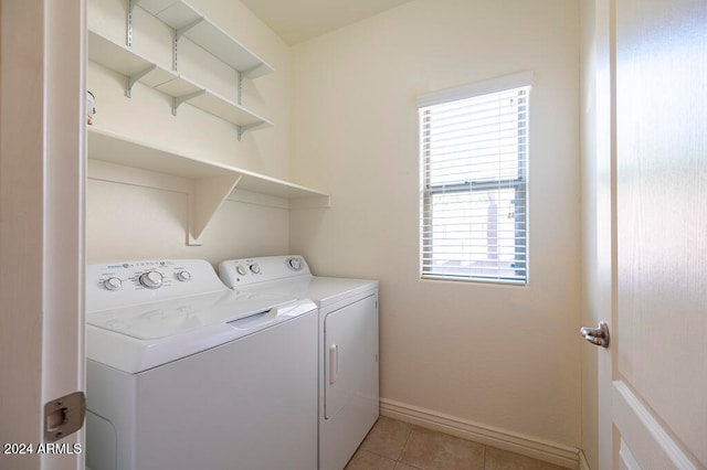 laundry area featuring washing machine and dryer and light tile patterned flooring