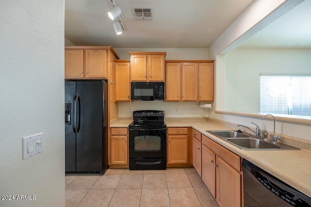 kitchen with track lighting, sink, black appliances, light tile patterned floors, and light brown cabinets