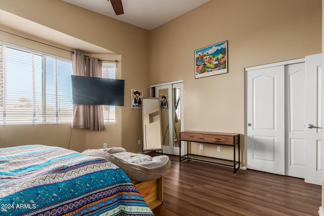 bedroom with multiple windows, dark hardwood / wood-style flooring, and ceiling fan