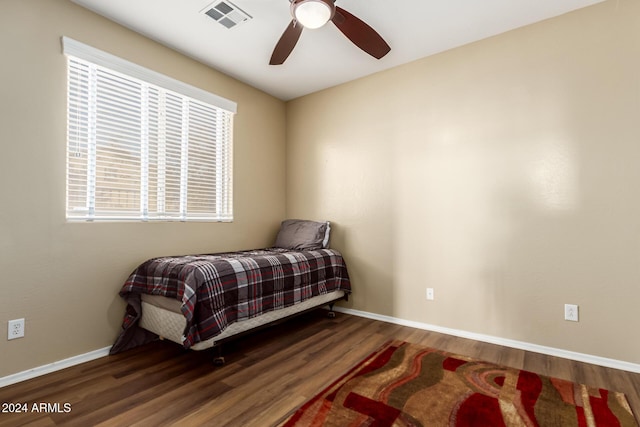 bedroom with ceiling fan and dark wood-type flooring