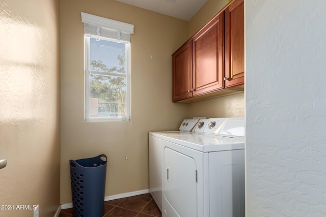 washroom featuring cabinets, tile patterned floors, and washing machine and clothes dryer