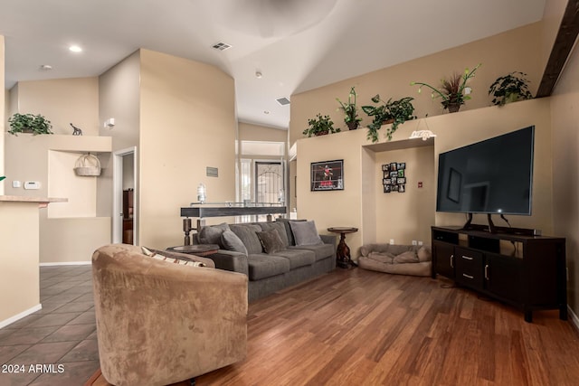 living room with dark hardwood / wood-style floors and lofted ceiling