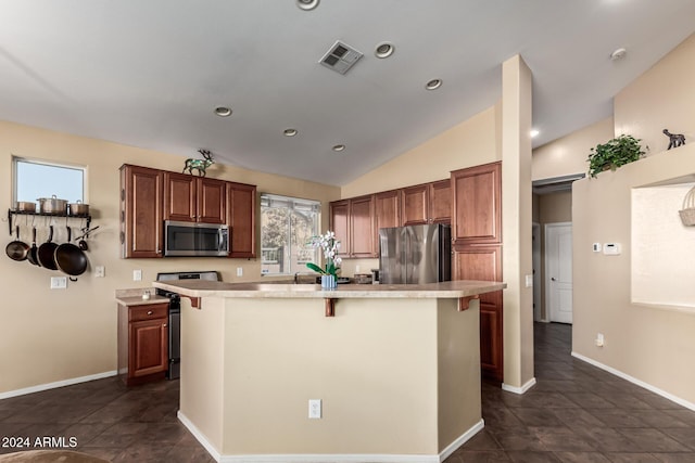 kitchen featuring a breakfast bar area, a kitchen island, stainless steel appliances, and vaulted ceiling