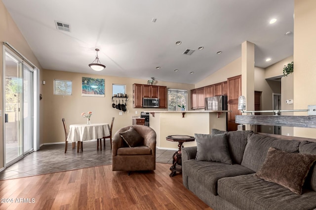 living room with hardwood / wood-style flooring and lofted ceiling