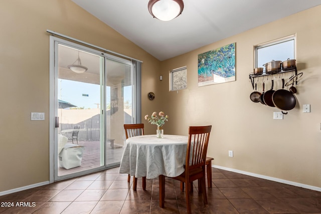 tiled dining area with lofted ceiling