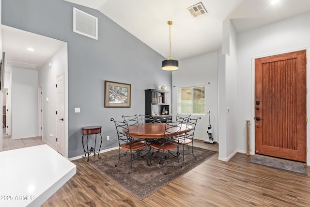 7031 S 32nd Pl, Phoenix, AZ 85042 - dining area featuring high vaulted ceiling, baseboards, and wood finished floors