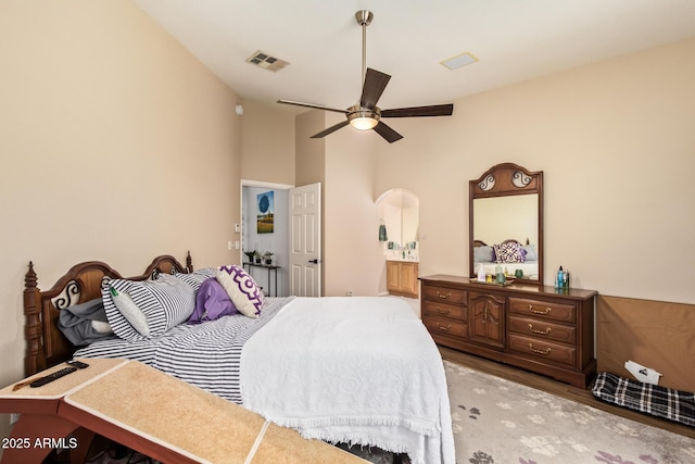 7031 S 32nd Pl, Phoenix, AZ 85042 - bedroom with light wood-style flooring, arched walkways, ceiling fan, and lofted ceiling