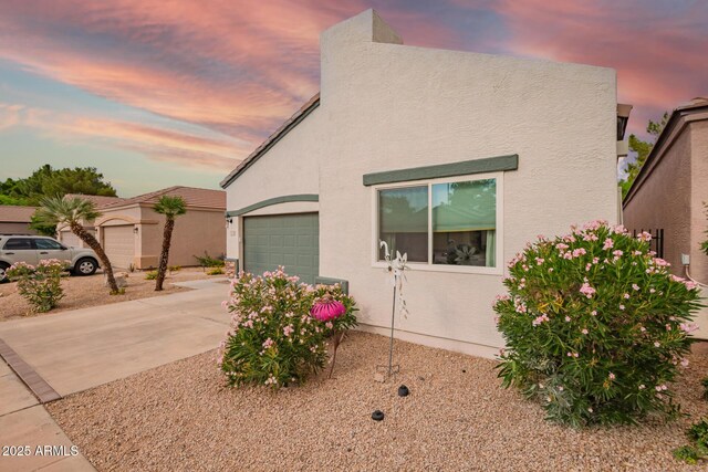 7031 S 32nd Pl, Phoenix, AZ 85042 - view of front of property featuring concrete driveway, a garage, and stucco siding