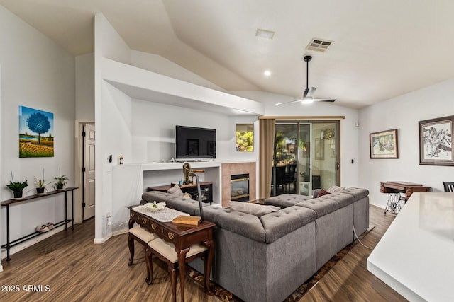 7031 S 32nd Pl, Phoenix, AZ 85042 - living area with vaulted ceiling, a tile fireplace, dark wood finished floors, ceiling fan, and recessed lighting