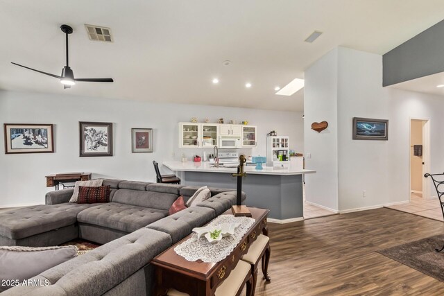 7031 S 32nd Pl, Phoenix, AZ 85042 - living room featuring wood finished floors, a ceiling fan, recessed lighting, and baseboards