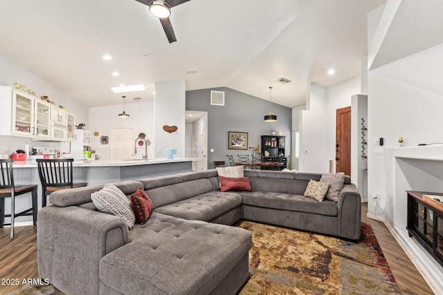 7031 S 32nd Pl, Phoenix, AZ 85042 - living area featuring wood finished floors, vaulted ceiling, and a ceiling fan