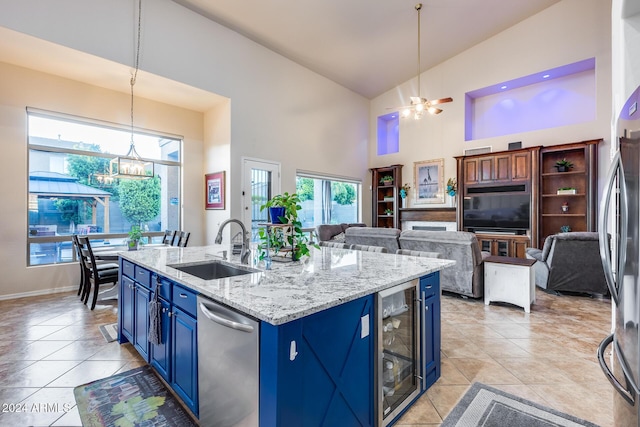 2728 W Adventure Dr, Anthem, AZ 85086 - kitchen with blue cabinets, appliances with stainless steel finishes, wine cooler, high vaulted ceiling, and open floor plan