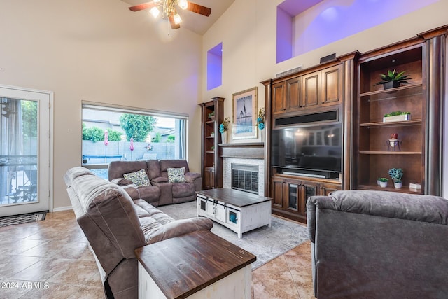 2728 W Adventure Dr, Anthem, AZ 85086 - living room featuring high vaulted ceiling, a ceiling fan, healthy amount of natural light, light tile patterned flooring, and a glass covered fireplace