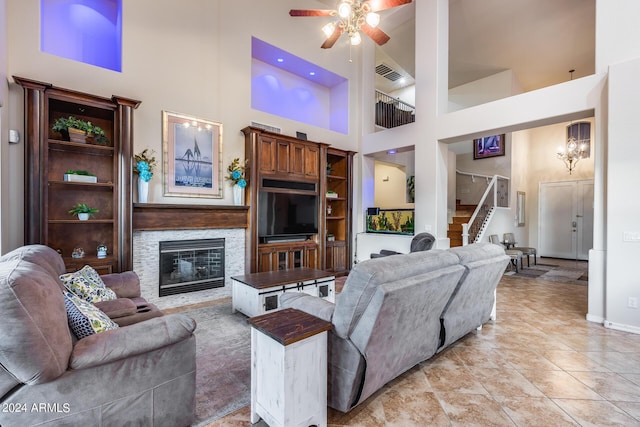 2728 W Adventure Dr, Anthem, AZ 85086 - living area featuring a high ceiling, ceiling fan, stairs, and a stone fireplace