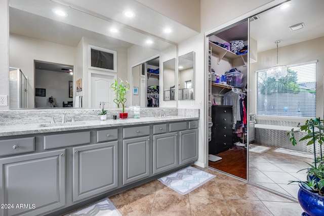 2728 W Adventure Dr, Anthem, AZ 85086 - full bath featuring double vanity, a spacious closet, a bath, recessed lighting, and tile patterned flooring