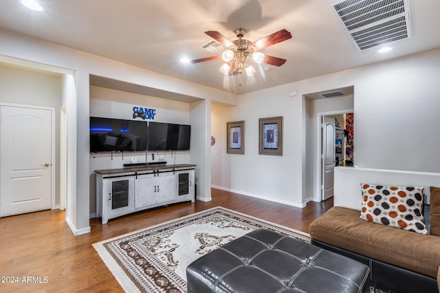 2728 W Adventure Dr, Anthem, AZ 85086 - living room featuring a ceiling fan, wood finished floors, recessed lighting, and bar with sink