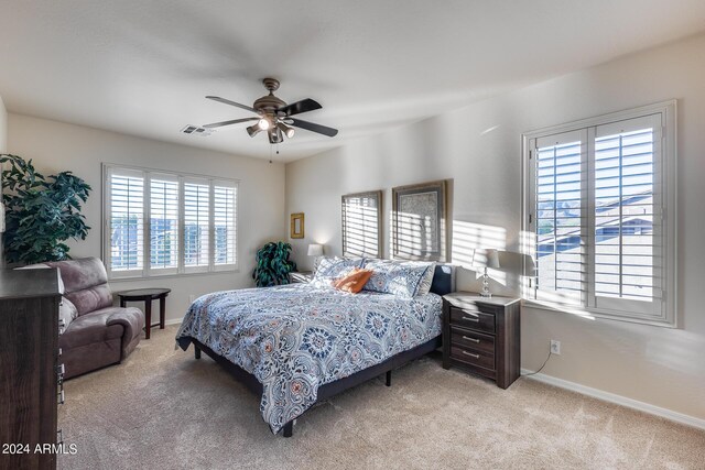 2728 W Adventure Dr, Anthem, AZ 85086 - bedroom featuring light carpet, multiple windows, and ceiling fan
