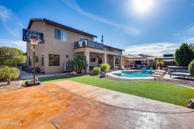 2728 W Adventure Dr, Anthem, AZ 85086 - back of property with a balcony, a hot tub, a gazebo, a patio area, and stucco siding