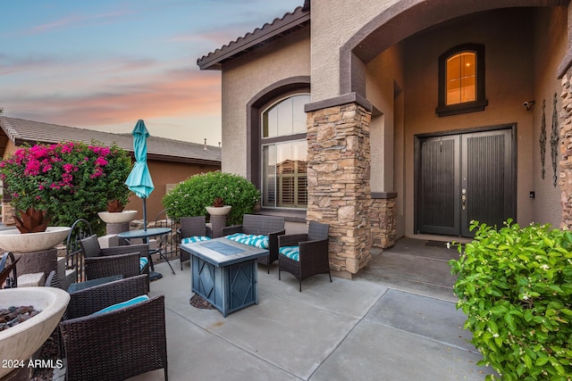 2728 W Adventure Dr, Anthem, AZ 85086 - patio terrace at dusk featuring a fire pit and a patio