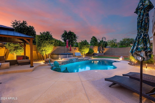 2728 W Adventure Dr, Anthem, AZ 85086 - pool at dusk featuring a patio, a fenced backyard, a gazebo, and a hot tub