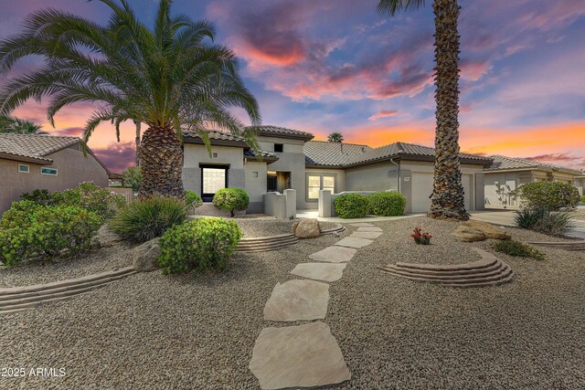 20454 N Palm Canyon Dr, Surprise, AZ 85374 - mediterranean / spanish-style home with a garage, stucco siding, driveway, and a tile roof