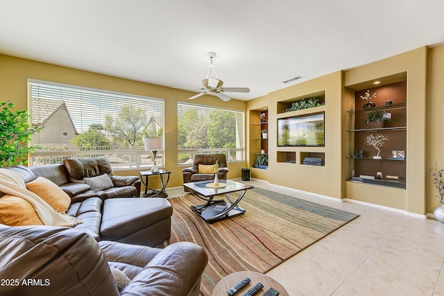 20454 N Palm Canyon Dr, Surprise, AZ 85374 - tiled living area featuring built in features, baseboards, a ceiling fan, and visible vents