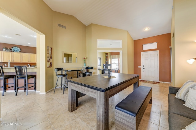20454 N Palm Canyon Dr, Surprise, AZ 85374 - dining space with high vaulted ceiling, light tile patterned flooring, baseboards, and visible vents