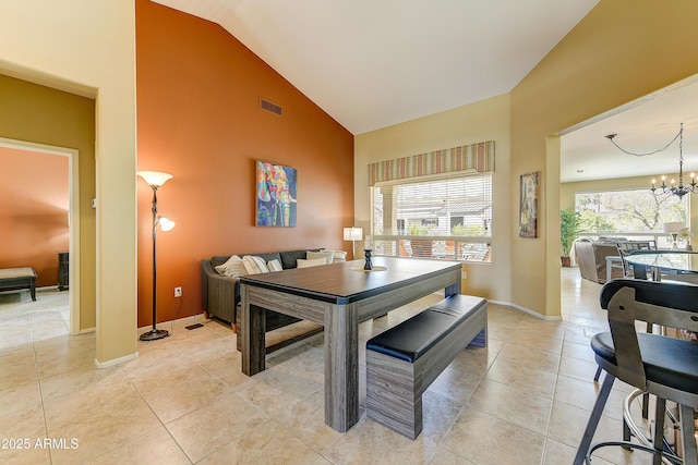 20454 N Palm Canyon Dr, Surprise, AZ 85374 - dining area with a notable chandelier, baseboards, light tile patterned floors, visible vents, and high vaulted ceiling