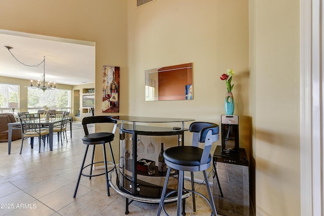 20454 N Palm Canyon Dr, Surprise, AZ 85374 - dining room featuring visible vents, tile patterned floors, a chandelier, and a high ceiling