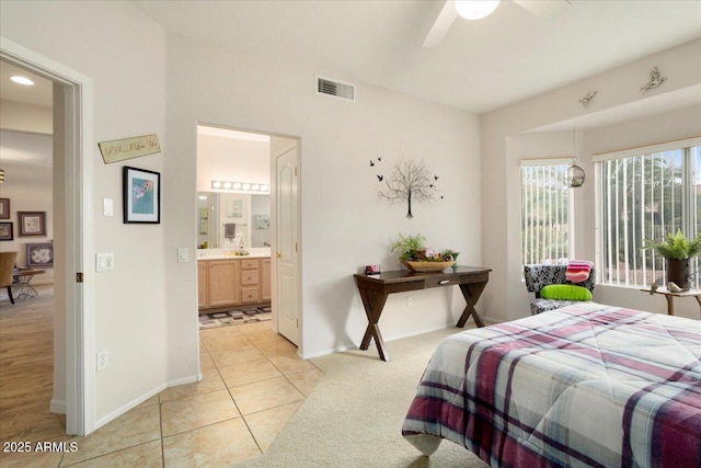 bedroom featuring light tile patterned floors and ensuite bath