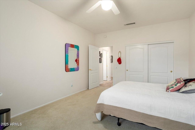 carpeted bedroom featuring ceiling fan and a closet