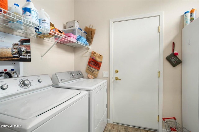 washroom featuring hardwood / wood-style flooring and separate washer and dryer