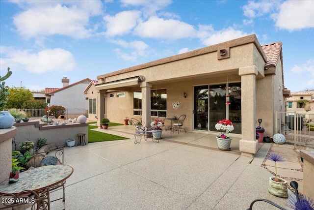 rear view of property featuring a patio area