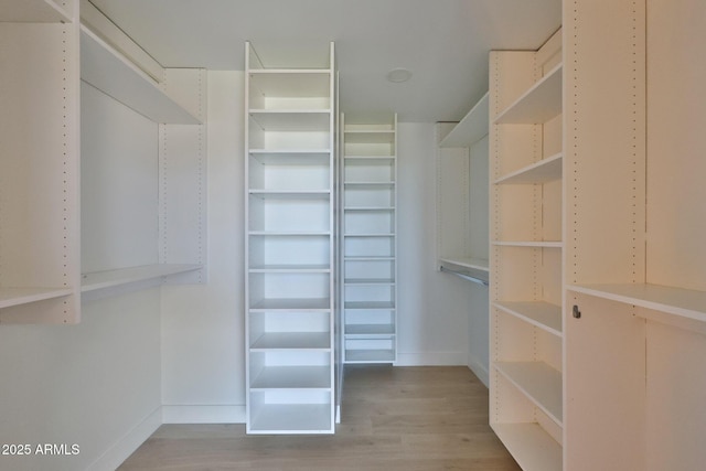 spacious closet with light wood-style floors