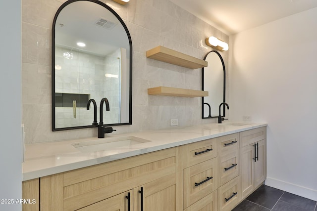 full bathroom with double vanity, visible vents, a sink, and tile patterned floors