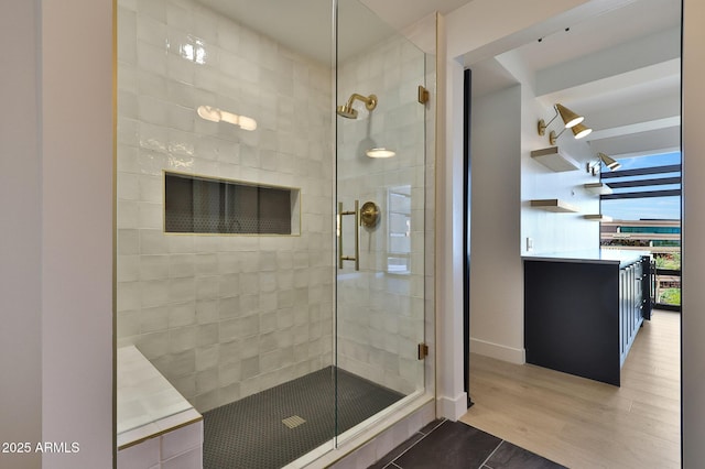 full bathroom featuring wood finished floors and a shower stall