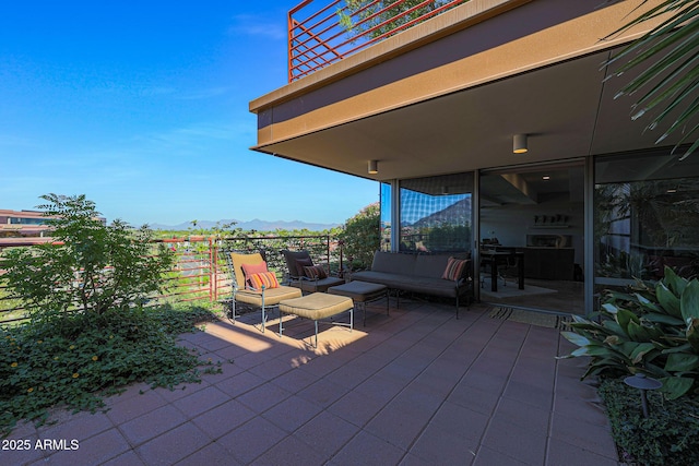 view of patio with a balcony and a mountain view