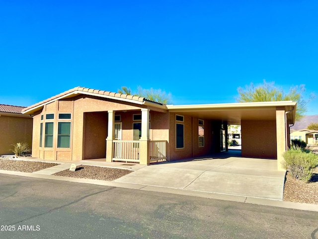 view of front of property featuring a carport and covered porch