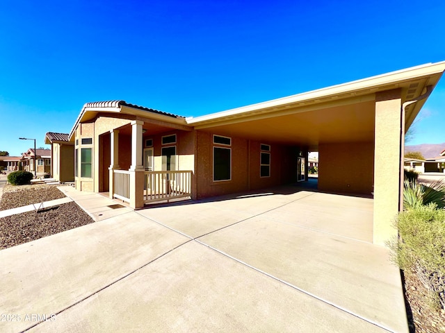 view of front of home featuring a carport and a porch