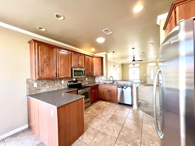 kitchen with sink, hanging light fixtures, ceiling fan, kitchen peninsula, and stainless steel appliances