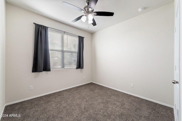 unfurnished room featuring ceiling fan and dark colored carpet