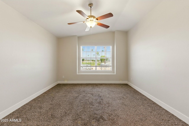 carpeted empty room featuring baseboards, a ceiling fan, and vaulted ceiling