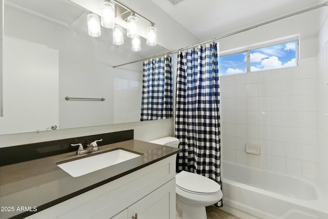 full bath with toilet, shower / tub combo with curtain, and vanity