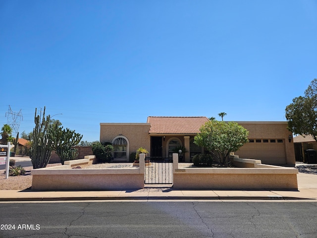 pueblo-style home featuring a garage