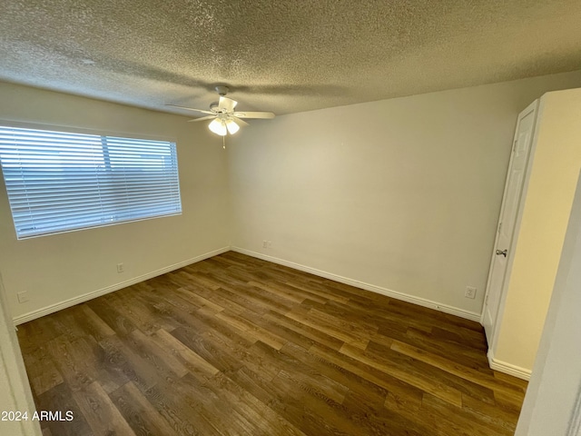 unfurnished room with dark hardwood / wood-style floors, ceiling fan, and a textured ceiling