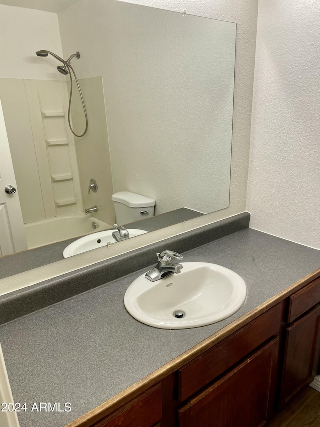 full bathroom with vanity, toilet, and shower / tub combination