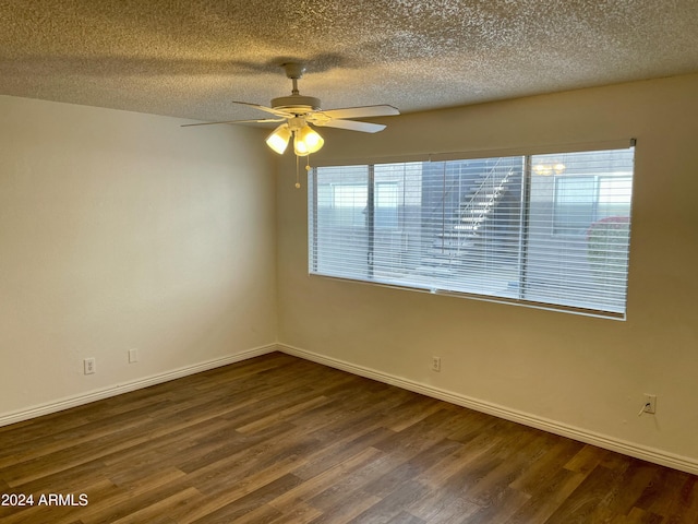 spare room featuring ceiling fan, dark hardwood / wood-style floors, and a textured ceiling