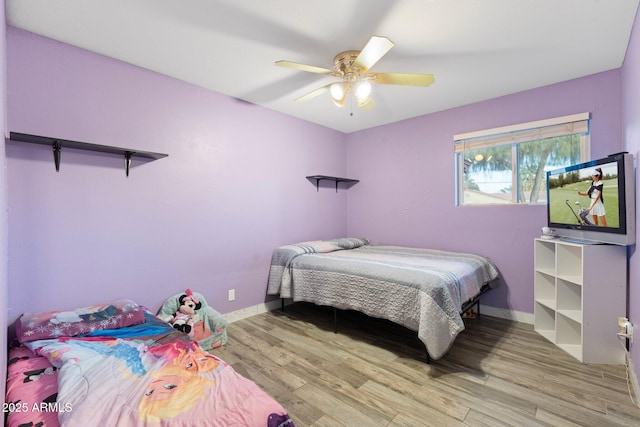 bedroom featuring hardwood / wood-style flooring and ceiling fan